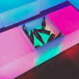 A vibrant and illuminated LED cube filled with bottles, perfect for rental.