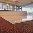 A glossy white dance floor in a large room, perfect for bridal events or table hire purposes.