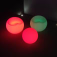Three lighted spheres sitting on a table.