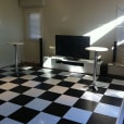 A living room with a black and white checkered floor.