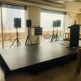 A room set up with speaker stands for hire, overlooking the city.