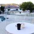 White table next to swimming pool.