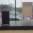 A stage with speakers and a lectern in front of a window.