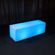 A blue LED cube sitting on top of a carpet, emitting a mesmerizing glow.