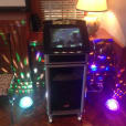 A jukebox hire in a room with colorful lights.