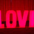 A large red "love" sign with glowing letters.