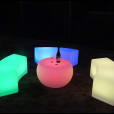 A set of colorful LED stools and a bottle of wine perfect for Glow Bench Hire events.