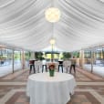 A 6m x 9m white tent with a table and chairs.