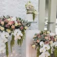 A large white square plinth hire, adorned with flowers and orchids