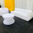 Glow Couch Hire: Transform your room with a stunning white couch and table ensemble. Perfect for creating a sleek and modern aesthetic, this set will brighten up any space.