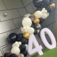 A black and gold balloon arch with the number 40 for a Glow Numbers Hire event.