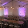 A tent set up with tables and Timber Trestle Table 1.8m Hire.