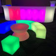 A large, colorful coffee table and chairs glow in the room.