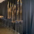 Clear acrylic plinths with candles on them.