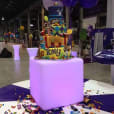 A large cake decorated with candy is sitting on a table.