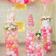 A pink and white birthday party with balloons and Clear Acrylic Round Plinth Hire - Set of 3.