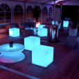 A group of colorful LED glow cubes on a wooden deck for hire.