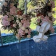 A flower arrangement with a letter l in the middle of a room, showcased on a Clear Acrylic Plinth.