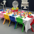 A table set up for a birthday party with balloons and kids chair hire.