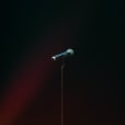 A wireless microphone in front of a dark background.