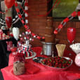 A table with a chocolate fountain overflowing with deliciously melted chocolate, accompanied by trays of ripe strawberries weighing 1kg.