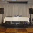 A DIY Party sound pack with a DJ set up in a room featuring speakers and speaker stands.