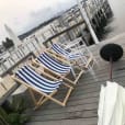 A deck chair and umbrella on a dock hired from Party Hire Group