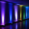 A room with Par Can lights casting vibrant colors in the background.