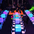 A Square Glow Banquet Table Hire room with tables and chairs set up for a party.