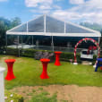 A party tent set up in a backyard using our red Lycra Socks