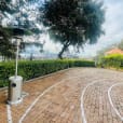 A brick walkway with a white track in the middle, decorated with two Mushroom Heaters.