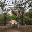 A garden gazebo with a table and chairs set in the middle, available for signing table hire.