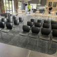 A conference room filled with black executive chairs.