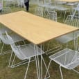 A white table on a grassy field