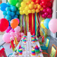A vibrant birthday party set up with balloons, decorations, and Kids Mesh Chair Hire.