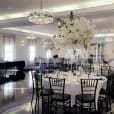 A black and white room with black Tiffany chair hire available for tables and chairs.