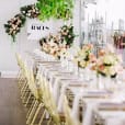 A beautifully decorated wedding reception table adorned with flowers and a sign.