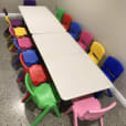 A vibrant space with an array of colorful plastic chairs and tables, perfect for Kids Chair Hire.