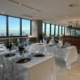 A restaurant with a stunning view of the city, offering Victorian Ghost Chair Hire for a unique dining experience.