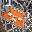 An orange and white display featuring wire arm chair hire with white velvet cushions in a mall.