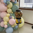         Candy Dispenser Machine Hire - Pkg 1: A gumball machine with balloons in front of it.