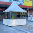 A white tent with a sign on it, available for Fete Stall/Tent Hire.