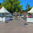 A white fete stall set up in a parking lot.