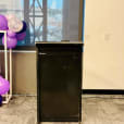 A podium with purple balloons in front of a window available for Lectern Hire.