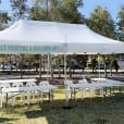 The park is adorned with a 3mx6m white tent, filled with tables and chairs for gatherings.