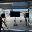 A speaker hire set up for a video shoot with a TV and tripods.