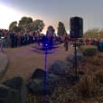 A crowd of people standing in front of a building, gathered for a Speaker Hire event.