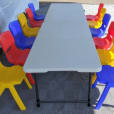 Kids Table Hire with a set of plastic chairs and a table in a tent.