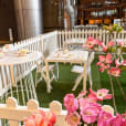 A white picket fence with pink flowers and cocktail tables.
Keywords: White Cocktail Table Hire