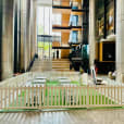 An office building lobby featuring a white picket fence as captivating decor.